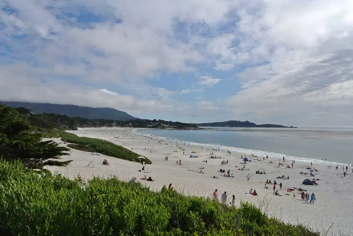 Carmel Beach on a clear day, white sand curving toward Pebble Beach