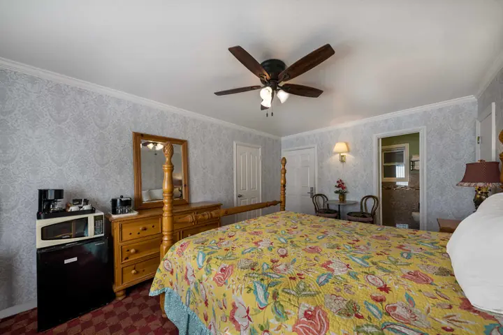 Standard King room showing the dresser, coffee maker, microwave and refrigerator